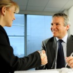 Picture of a man and a woman shaking hands during an interview